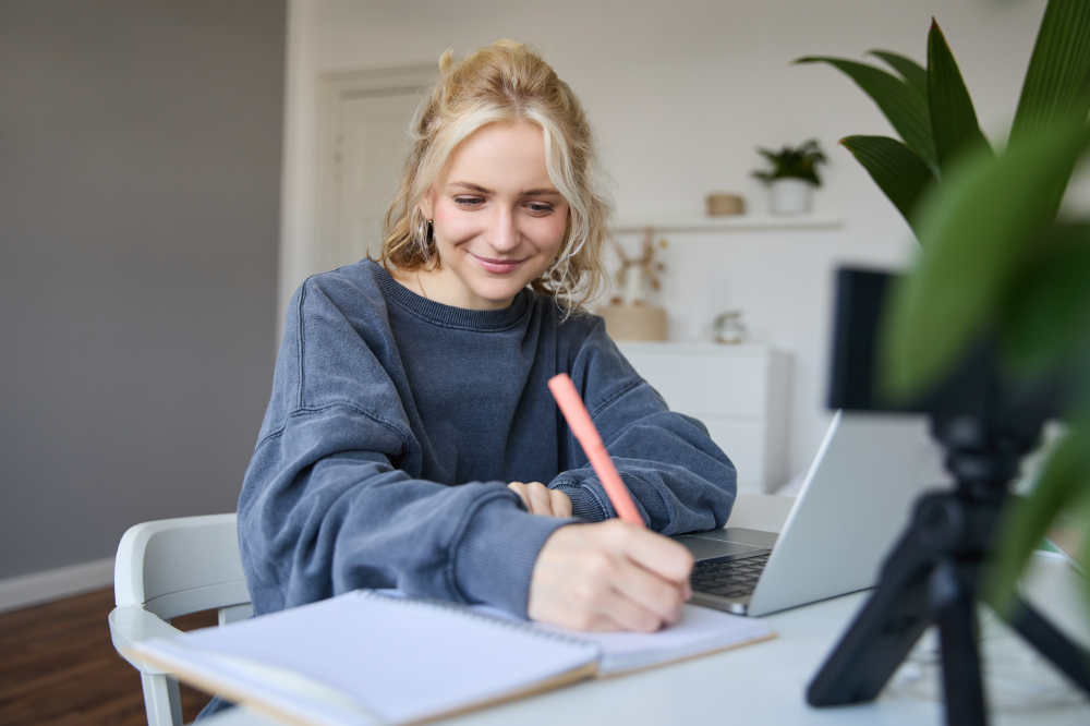 Portrait of young woman making notes